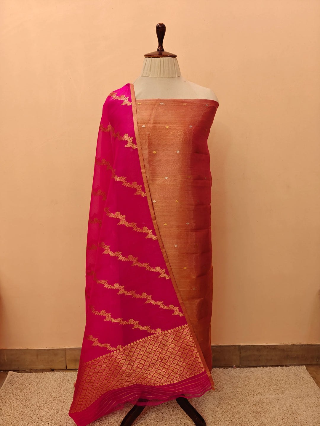 Rani Pink Banarasi Tissue Silk suit with golden and silver Kadhwa butis on the kurta, paired with a Kora silk dupatta featuring intricate jaal work.