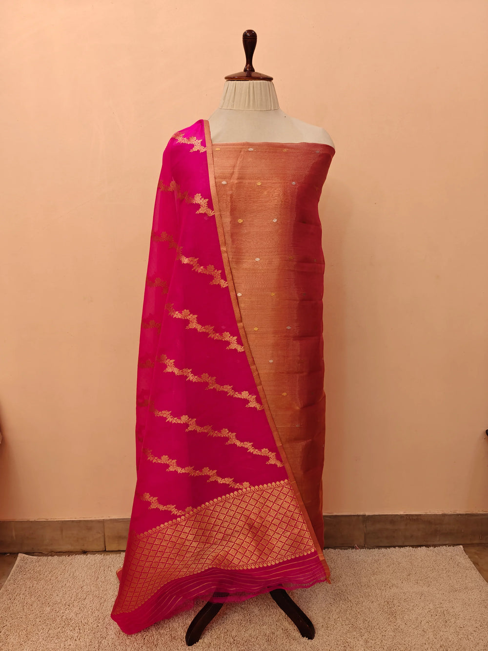 Rani Pink Banarasi Tissue Silk suit with golden and silver Kadhwa butis on the kurta, paired with a Kora silk dupatta featuring intricate jaal work.