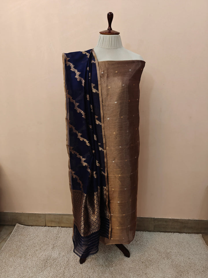 Navy Blue Banarasi Tissue Silk suit with golden and silver Kadhwa butis on the kurta, paired with a Kora silk dupatta featuring intricate jaal work.