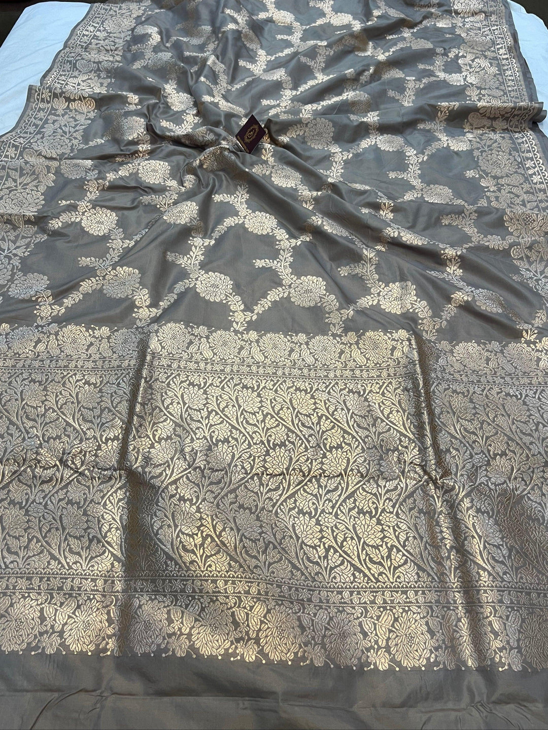Pure Katan silk handloom saree draped with light golden zari floral jaal and elegant border