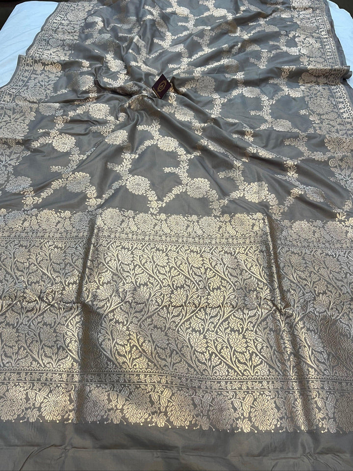 Pure Katan silk handloom saree draped with light golden zari floral jaal and elegant border