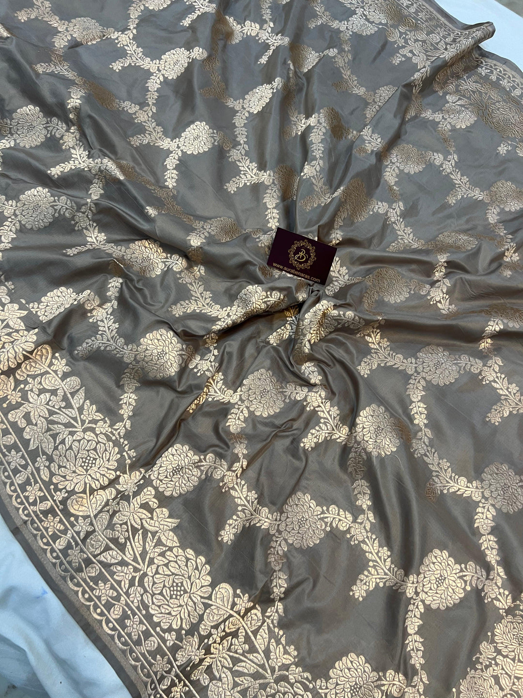 Light golden zari border and palla beautifully complementing the floral jaal design on Katan silk saree