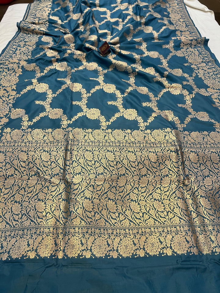 Pure Katan silk handloom saree draped with light golden zari floral jaal and elegant border