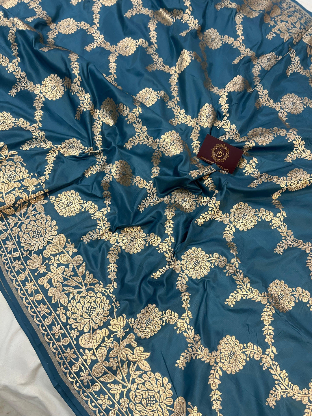 Light golden zari border and palla beautifully complementing the floral jaal design on Katan silk saree