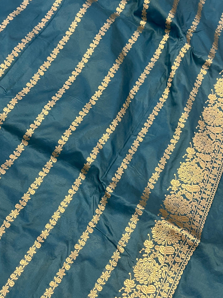 Plain blouse piece with golden zari lines included with the pure Katan silk Banarasi saree
