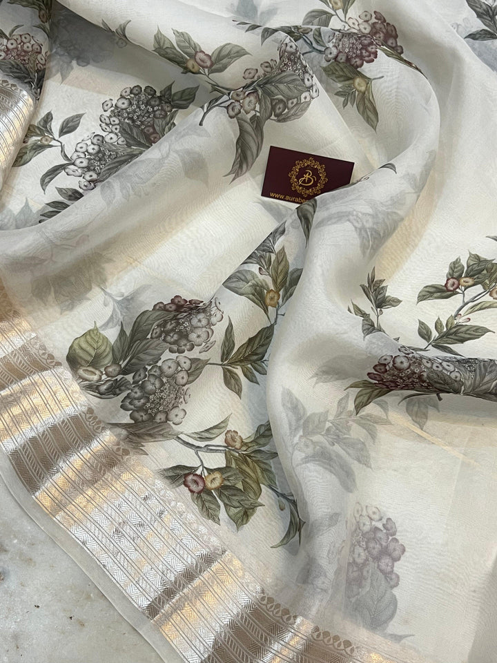 Pure Banarasi Kora silk saree with floral digital print, silver zari Banarasi border, and matching Chiniya silk blouse piece—ideal for festive and elegant occasions.