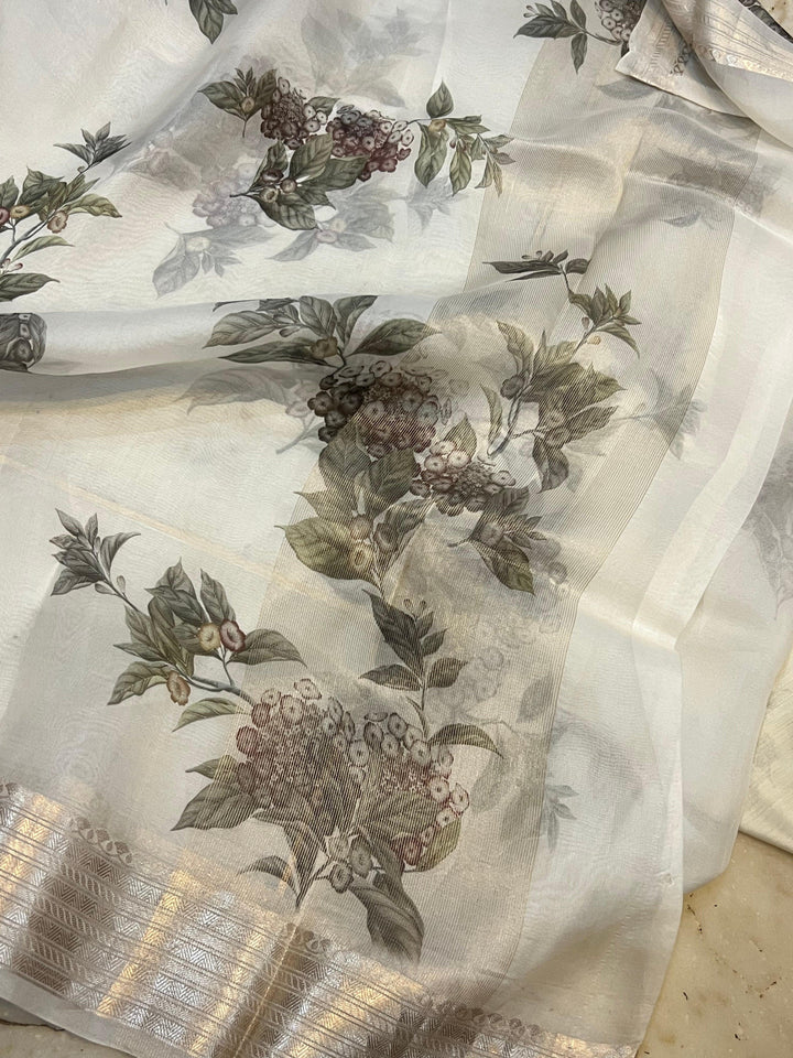 Pure Banarasi Kora silk saree with floral digital print, silver zari Banarasi border, and matching Chiniya silk blouse piece—ideal for festive and elegant occasions.