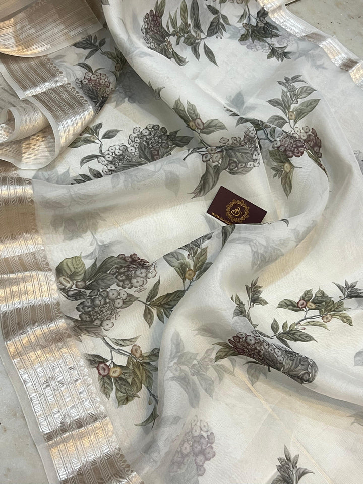 Pure Banarasi Kora silk saree with floral digital print, silver zari Banarasi border, and matching Chiniya silk blouse piece—ideal for festive and elegant occasions.