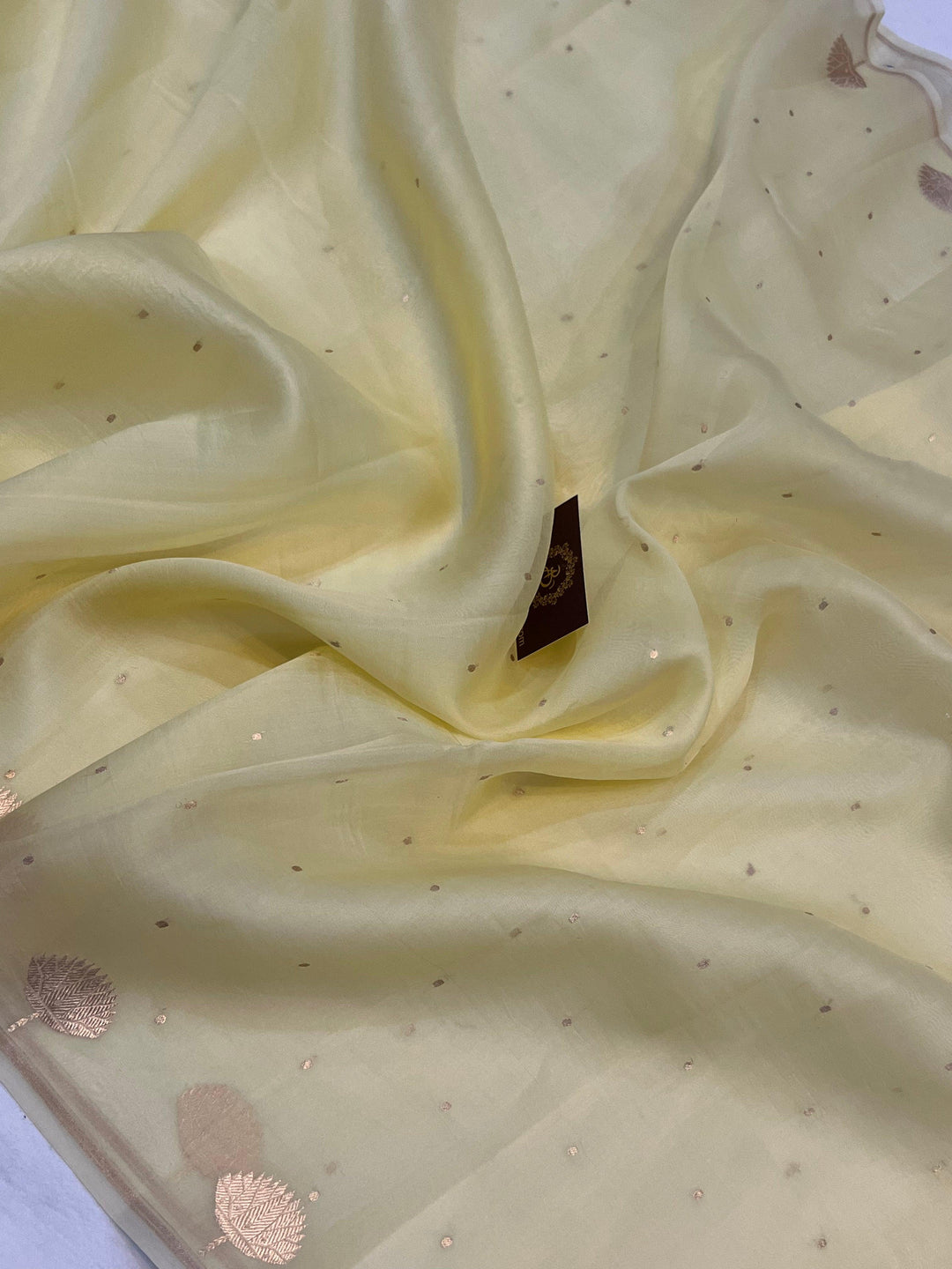 Pure Banarasi handloom Kora silk saree by Aura Benaras with small Kadhwa butis, a designer Banarasi border with Kadhwa butas, and silk blouse featuring golden zari stripes—ideal for weddings and festive