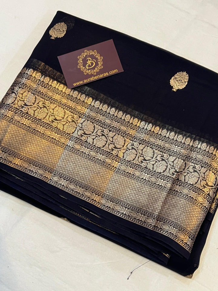 Pure Banarasi handloom Kora silk saree by Aura Benaras, featuring intricate Kadhwa butas and a beautiful traditional Banarasi border—ideal for weddings, festive wear, and special occasions.