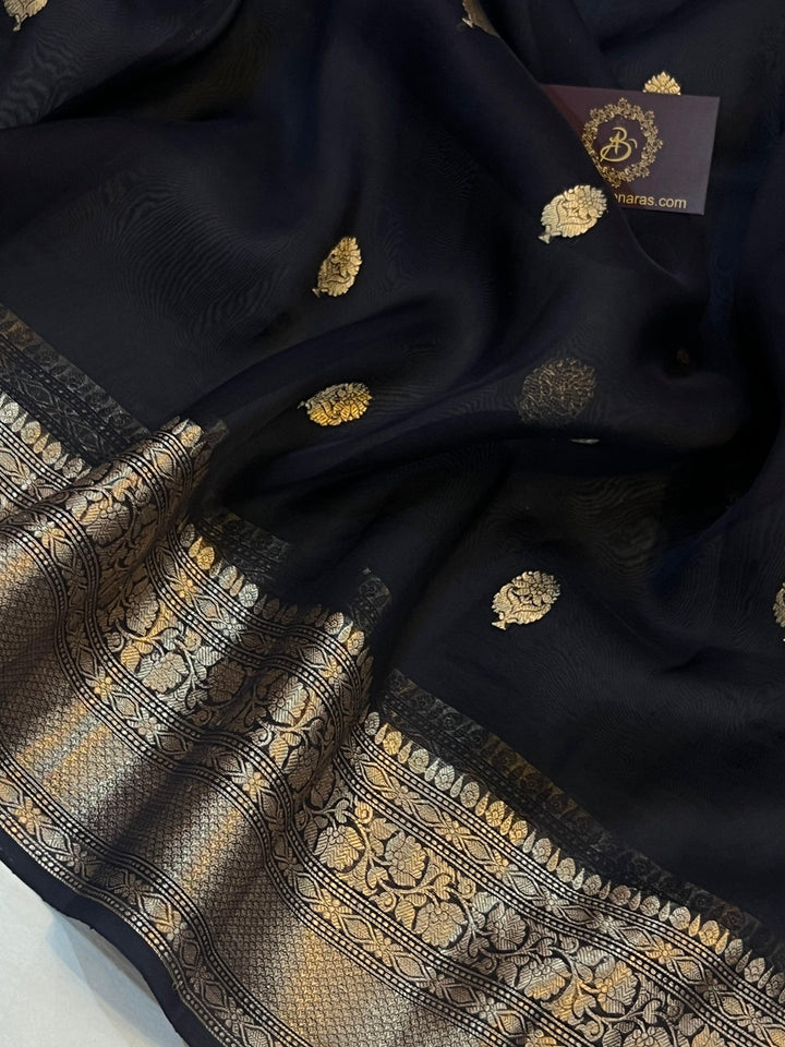 Pure Banarasi handloom Kora silk saree by Aura Benaras, featuring intricate Kadhwa butas and a beautiful traditional Banarasi border—ideal for weddings, festive wear, and special occasions.