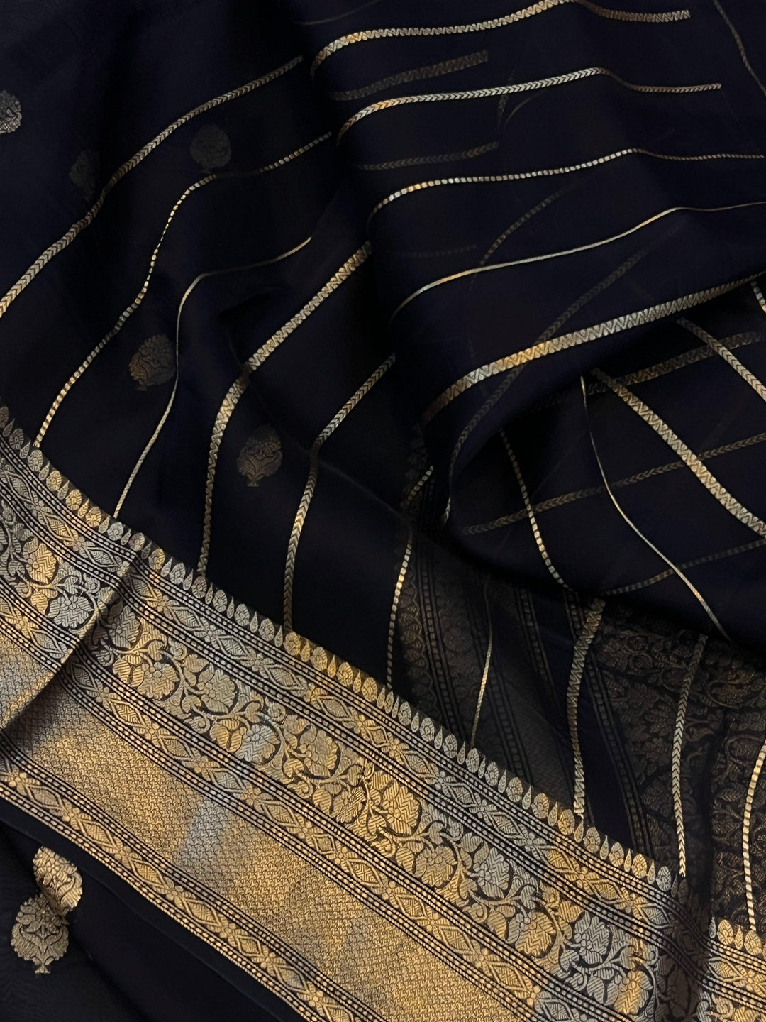 Pure Banarasi handloom Kora silk saree by Aura Benaras, featuring intricate Kadhwa butas and a beautiful traditional Banarasi border—ideal for weddings, festive wear, and special occasions.