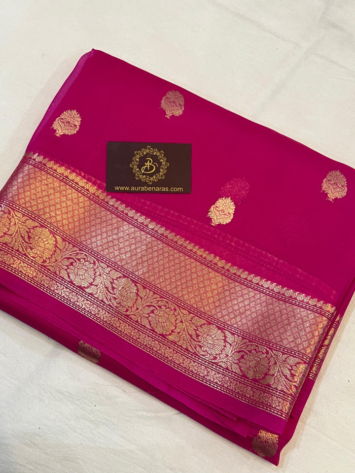 Pure Banarasi handloom Kora silk saree by Aura Benaras, featuring intricate Kadhwa butas and a beautiful traditional Banarasi border—ideal for weddings, festive wear, and special occasions.