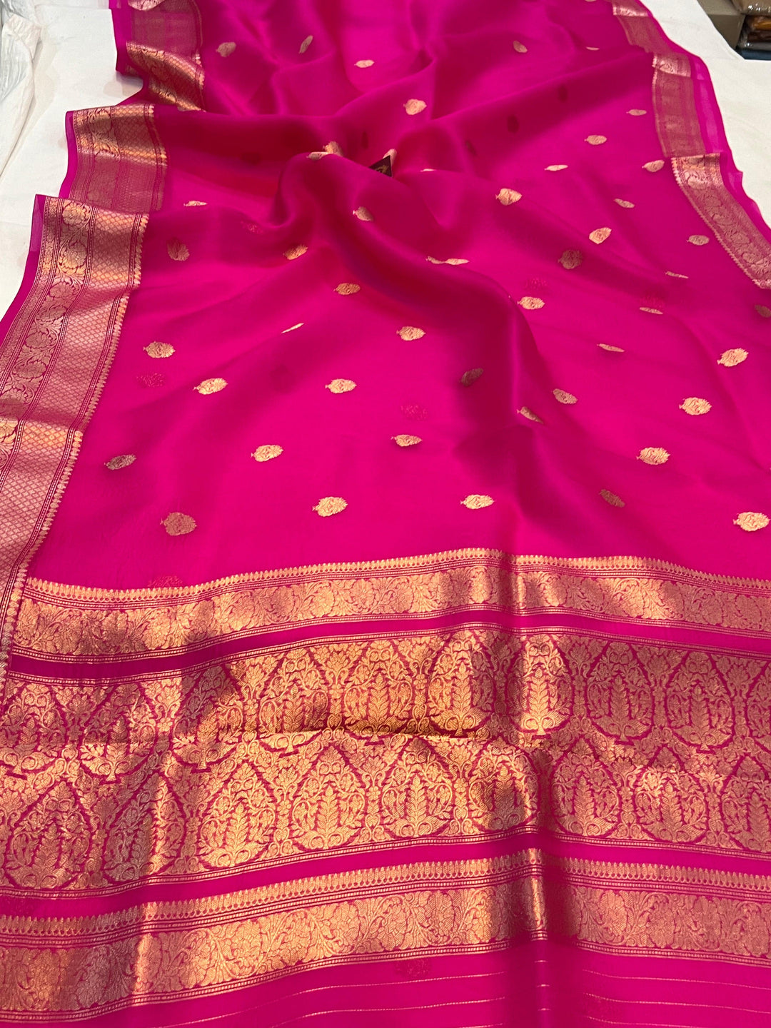 Pure Banarasi handloom Kora silk saree by Aura Benaras, featuring intricate Kadhwa butas and a beautiful traditional Banarasi border—ideal for weddings, festive wear, and special occasions.