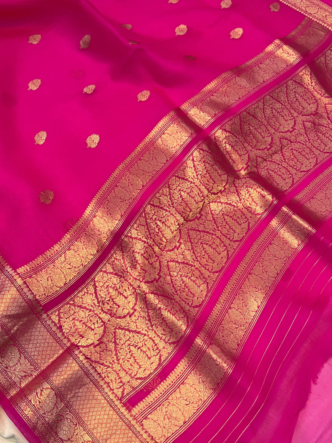 Pure Banarasi handloom Kora silk saree by Aura Benaras, featuring intricate Kadhwa butas and a beautiful traditional Banarasi border—ideal for weddings, festive wear, and special occasions.