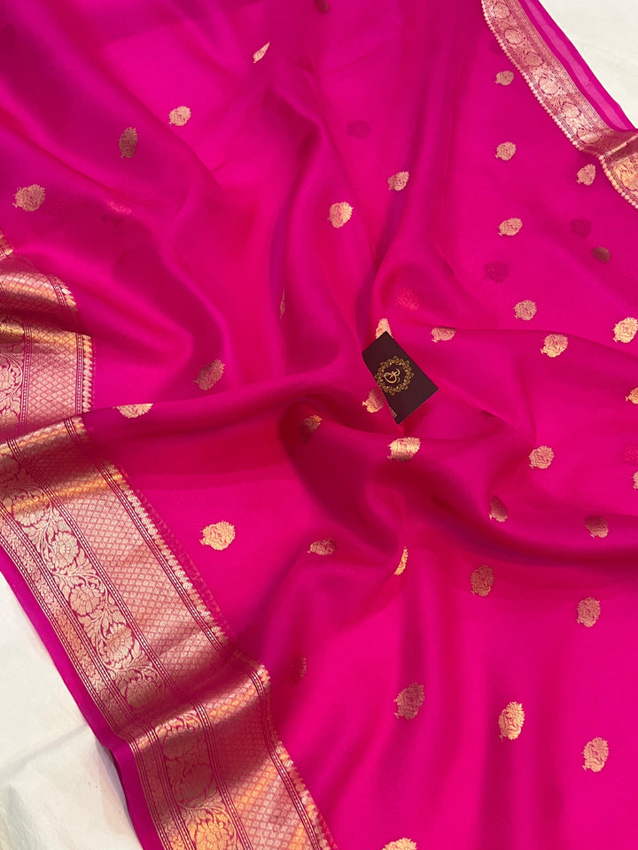 Pure Banarasi handloom Kora silk saree by Aura Benaras, featuring intricate Kadhwa butas and a beautiful traditional Banarasi border—ideal for weddings, festive wear, and special occasions.