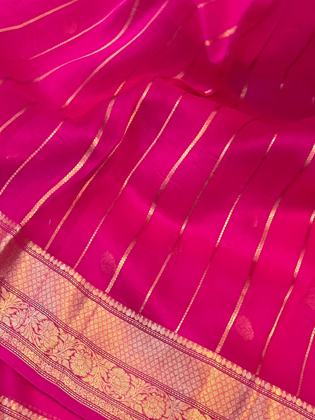 Pure Banarasi handloom Kora silk saree by Aura Benaras, featuring intricate Kadhwa butas and a beautiful traditional Banarasi border—ideal for weddings, festive wear, and special occasions.