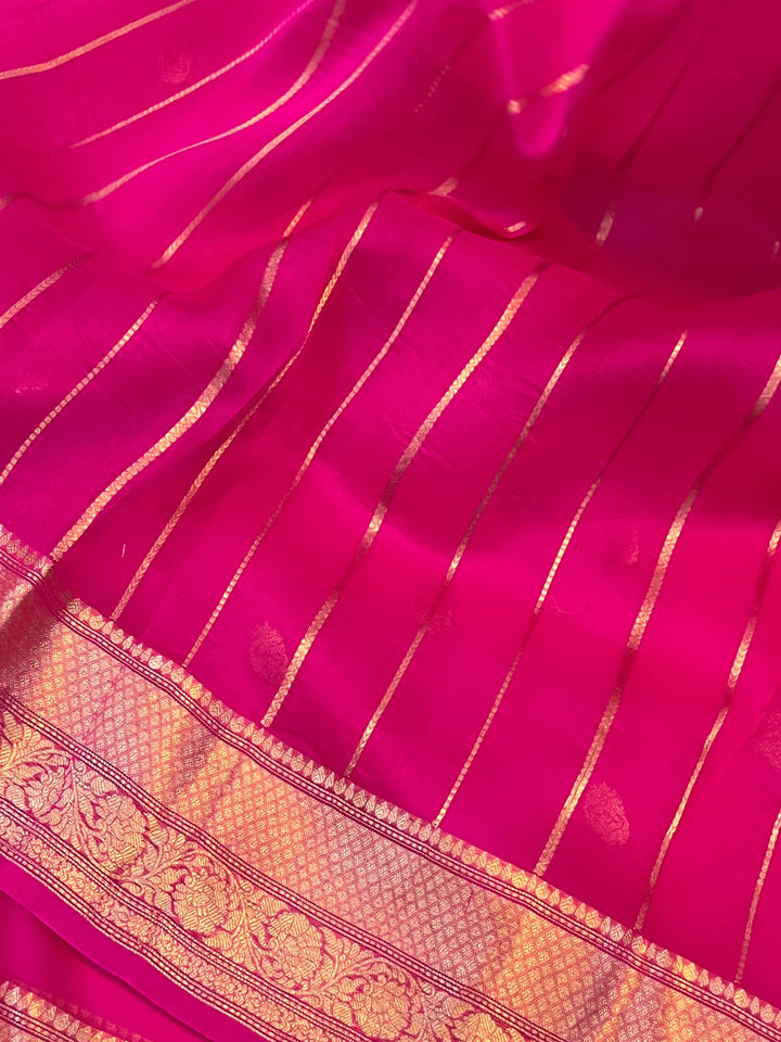 Pure Banarasi handloom Kora silk saree by Aura Benaras, featuring intricate Kadhwa butas and a beautiful traditional Banarasi border—ideal for weddings, festive wear, and special occasions.