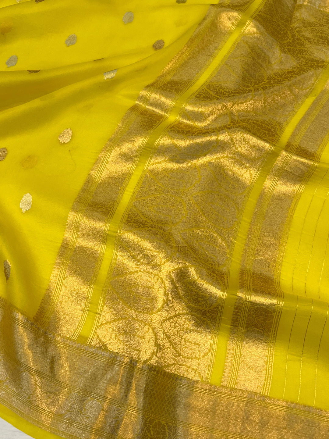 Pure Banarasi handloom Kora silk saree by Aura Benaras, featuring intricate Kadhwa butas and a beautiful traditional Banarasi border—ideal for weddings, festive wear, and special occasions.