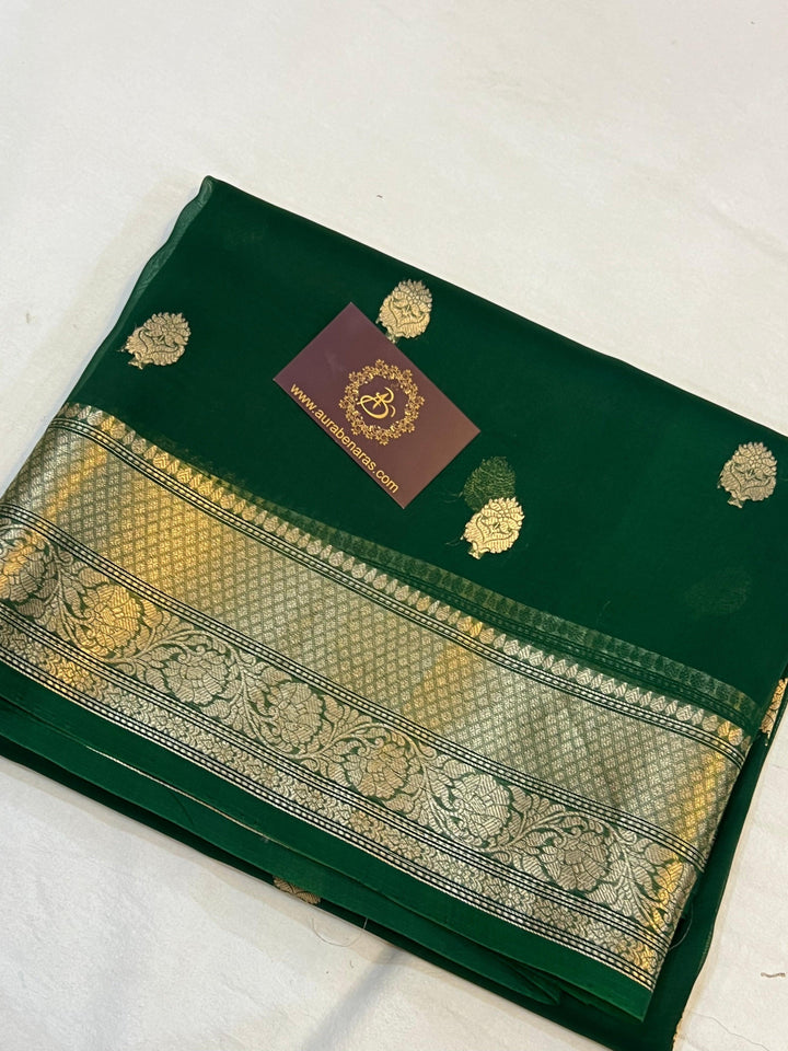 Pure Banarasi handloom Kora silk saree by Aura Benaras, featuring intricate Kadhwa butas and a beautiful traditional Banarasi border—ideal for weddings, festive wear, and special occasions.