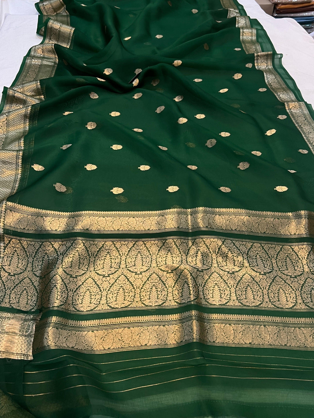Pure Banarasi handloom Kora silk saree by Aura Benaras, featuring intricate Kadhwa butas and a beautiful traditional Banarasi border—ideal for weddings, festive wear, and special occasions.