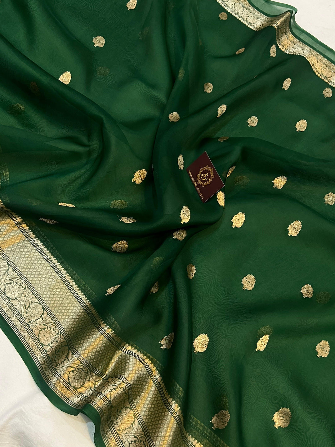 Pure Banarasi handloom Kora silk saree by Aura Benaras, featuring intricate Kadhwa butas and a beautiful traditional Banarasi border—ideal for weddings, festive wear, and special occasions.