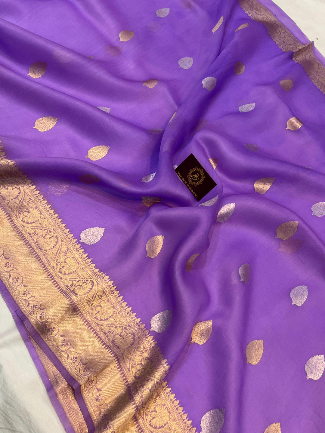 Pure Banarasi handloom Kora silk saree by Aura Benaras, featuring intricate Kadhwa butas and a beautiful traditional Banarasi border—ideal for weddings, festive wear, and special occasions.