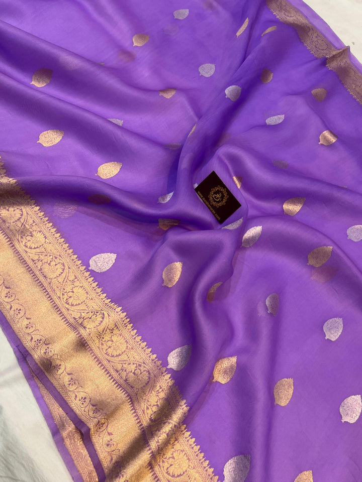 Pure Banarasi handloom Kora silk saree by Aura Benaras, featuring intricate Kadhwa butas and a beautiful traditional Banarasi border—ideal for weddings, festive wear, and special occasions.