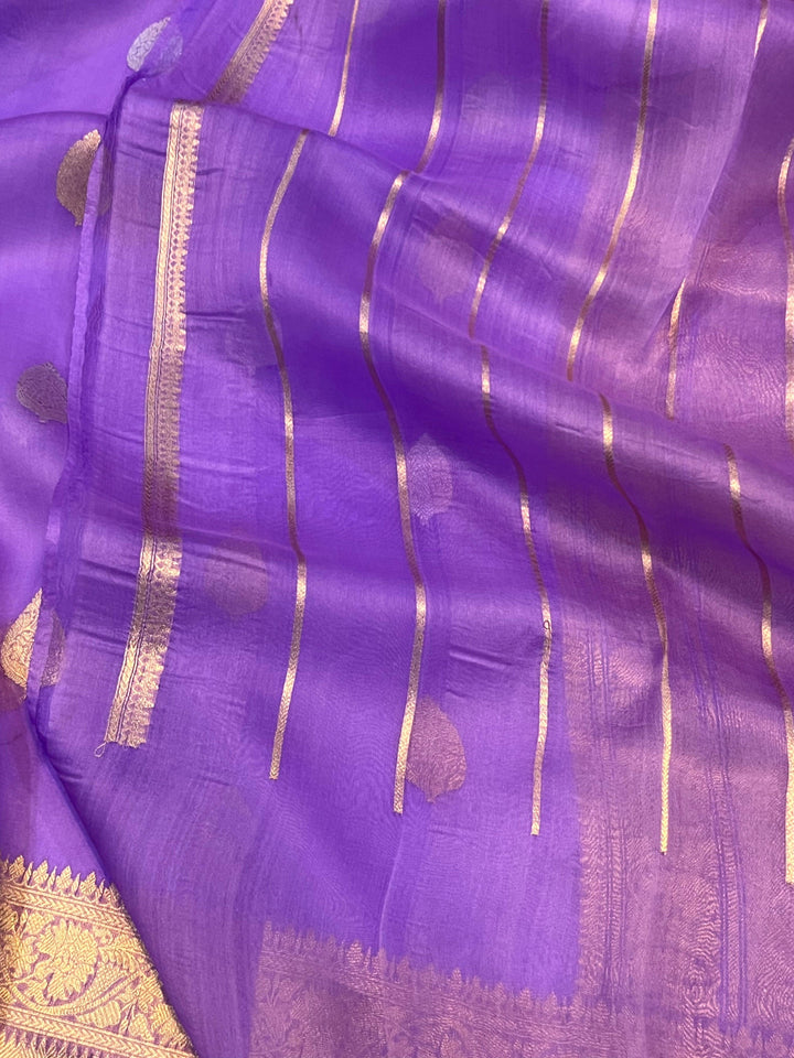 Pure Banarasi handloom Kora silk saree by Aura Benaras, featuring intricate Kadhwa butas and a beautiful traditional Banarasi border—ideal for weddings, festive wear, and special occasions.