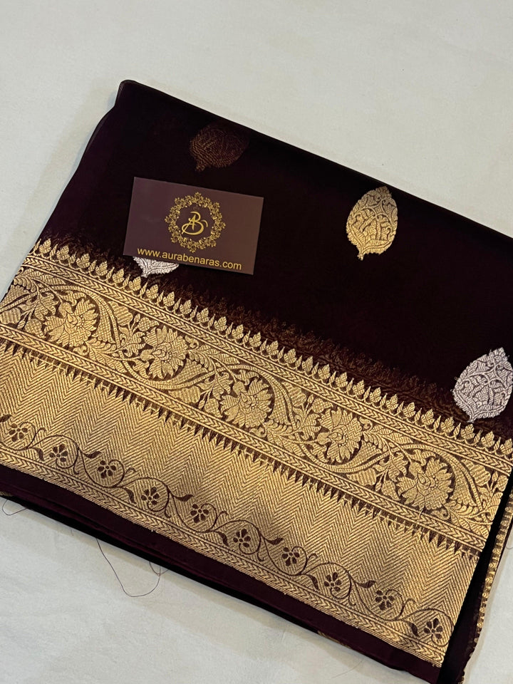 Pure Banarasi handloom Kora silk saree by Aura Benaras, featuring intricate Kadhwa butas and a beautiful traditional Banarasi border—ideal for weddings, festive wear, and special occasions.