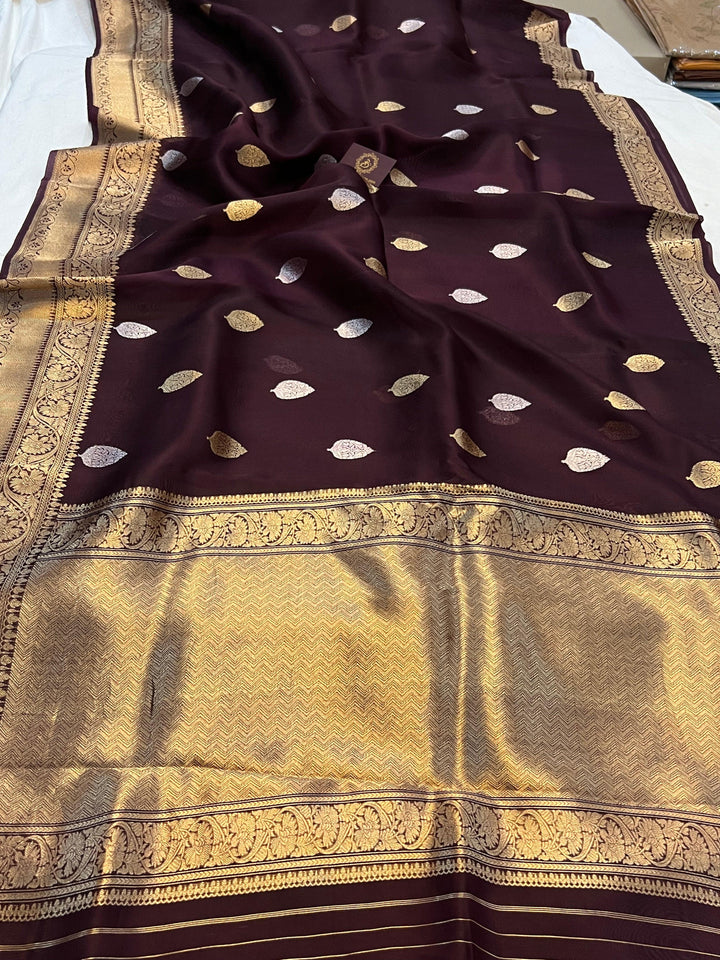 Pure Banarasi handloom Kora silk saree by Aura Benaras, featuring intricate Kadhwa butas and a beautiful traditional Banarasi border—ideal for weddings, festive wear, and special occasions.