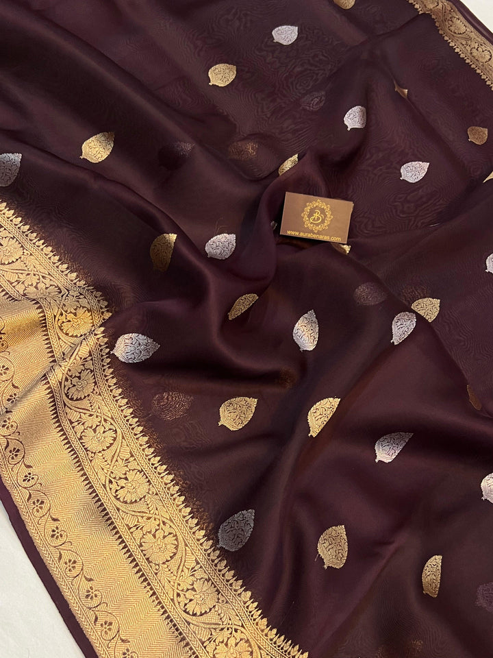 Pure Banarasi handloom Kora silk saree by Aura Benaras, featuring intricate Kadhwa butas and a beautiful traditional Banarasi border—ideal for weddings, festive wear, and special occasions.