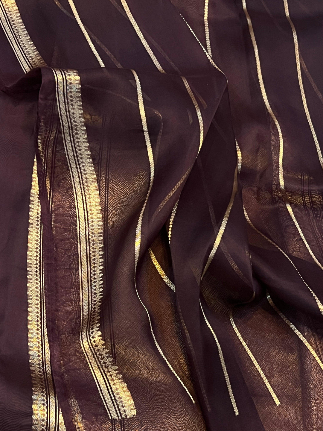 Pure Banarasi handloom Kora silk saree by Aura Benaras, featuring intricate Kadhwa butas and a beautiful traditional Banarasi border—ideal for weddings, festive wear, and special occasions.