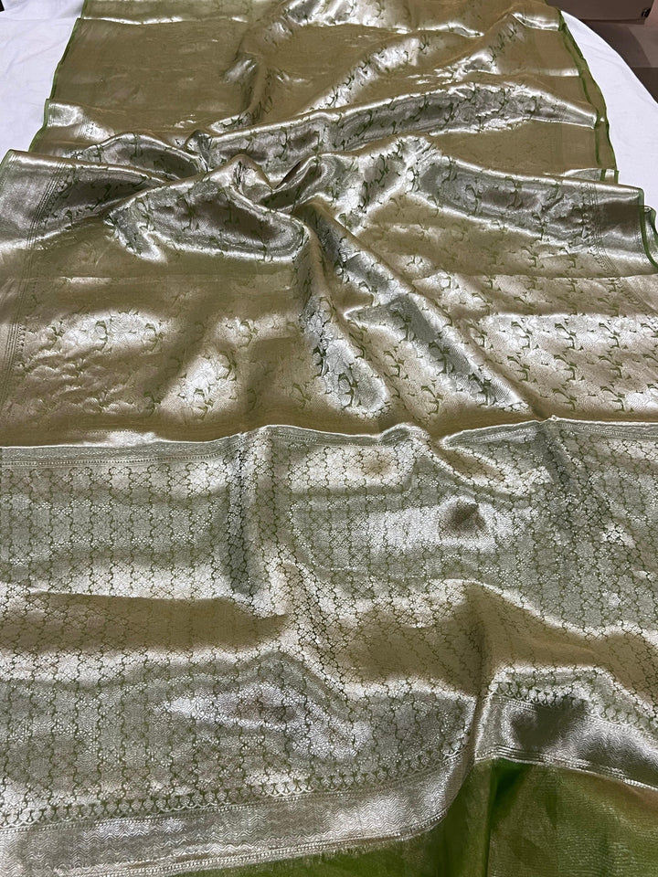 Pure Banarasi handloom tissue silk saree by Aura Benaras featuring intricate brocade work and a plain blouse piece—ideal for weddings and festive occasions.