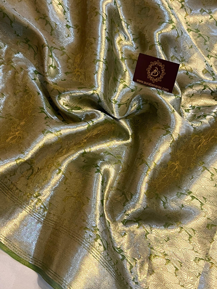 Pure Banarasi handloom tissue silk saree by Aura Benaras featuring intricate brocade work and a plain blouse piece—ideal for weddings and festive occasions.