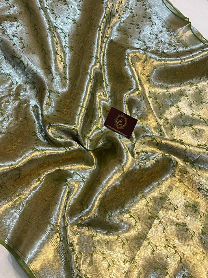 Pure Banarasi handloom tissue silk saree by Aura Benaras featuring intricate brocade work and a plain blouse piece—ideal for weddings and festive occasions.