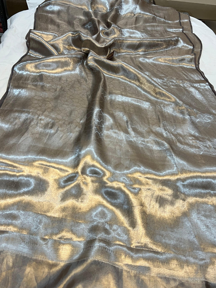 Pure Banarasi handloom tissue silk saree by Aura Benaras featuring intricate brocade work and a plain blouse piece—ideal for weddings and festive occasions.