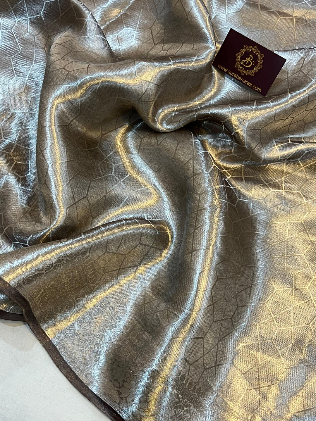 Pure Banarasi handloom tissue silk saree by Aura Benaras featuring intricate brocade work and a plain blouse piece—ideal for weddings and festive occasions.