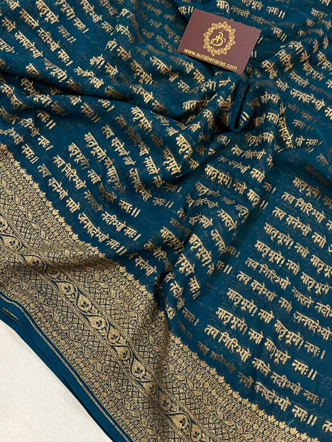 Teal Blue Pure Banarasi Khaddi Georgette saree with antique zari and Sanskrit shloka motifs