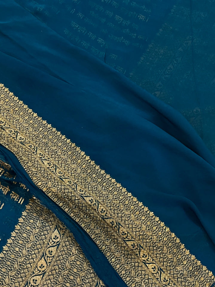 Teal Blue Pure Banarasi Khaddi Georgette saree with antique zari and Sanskrit shloka motifs