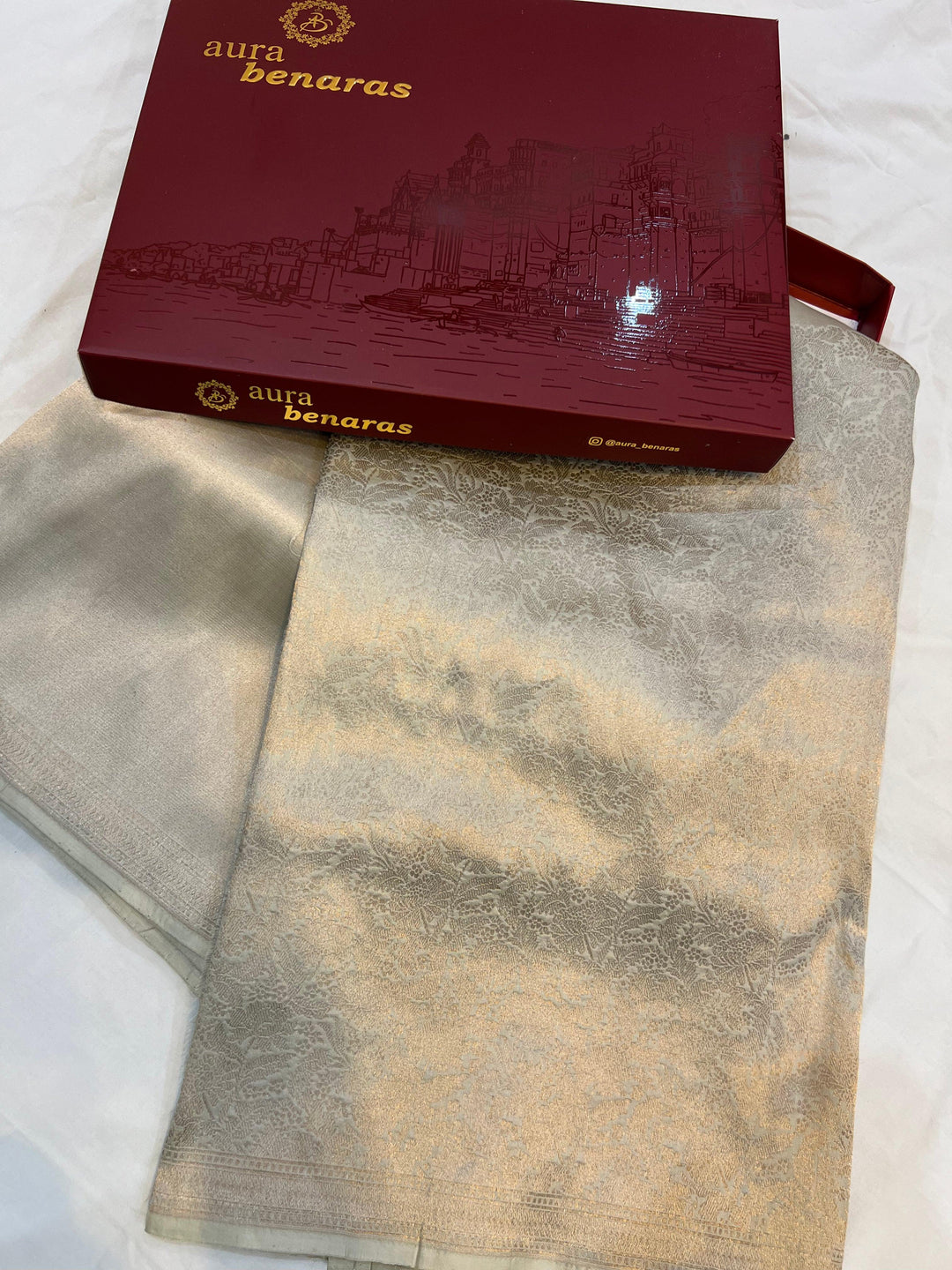 Folded view highlighting the floral brocade work and plain upper half of the pure Katan silk Banarasi saree