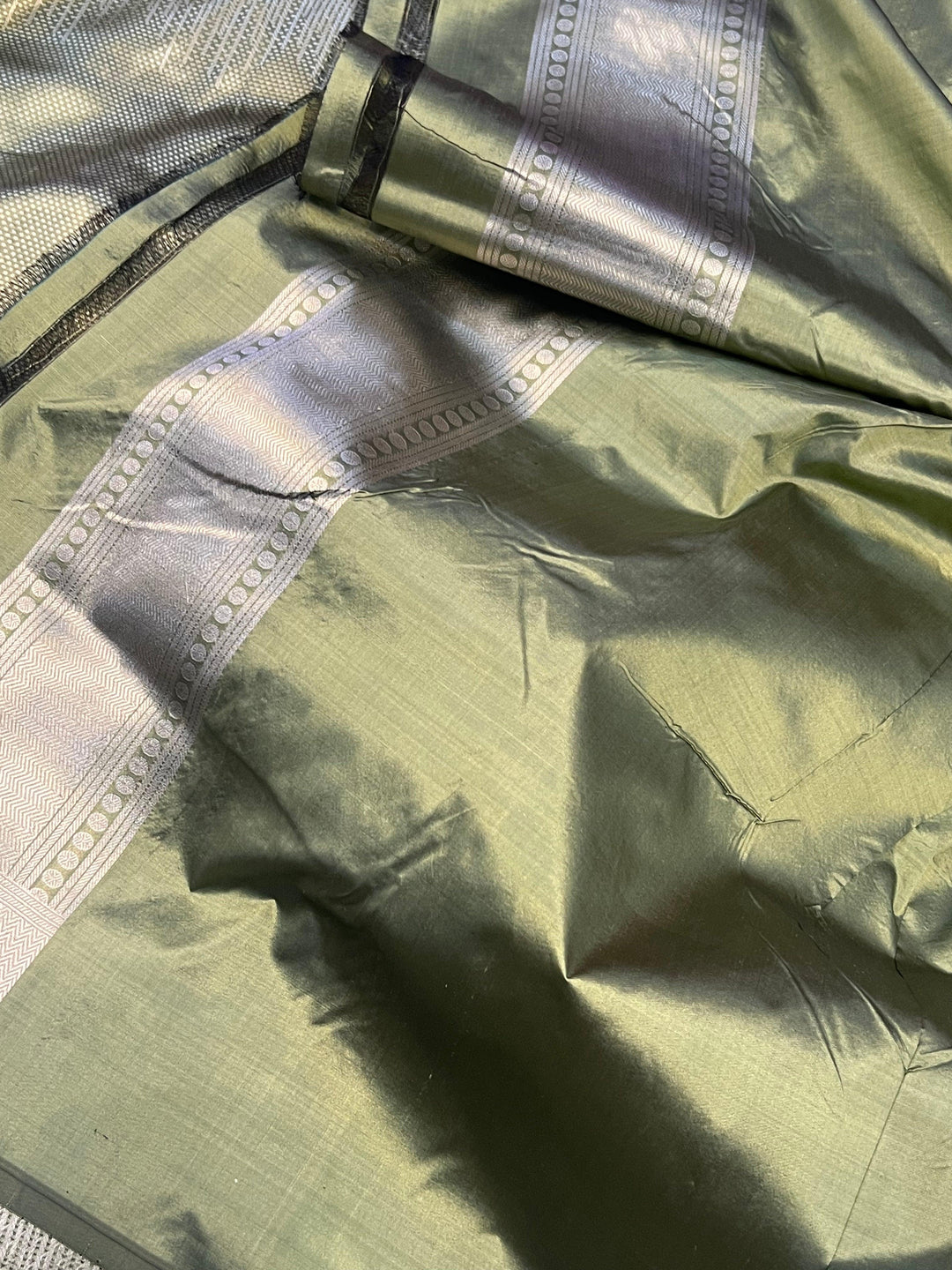 Woven dots creating a 3D effect in the middle section of pure Katan silk Banarasi saree