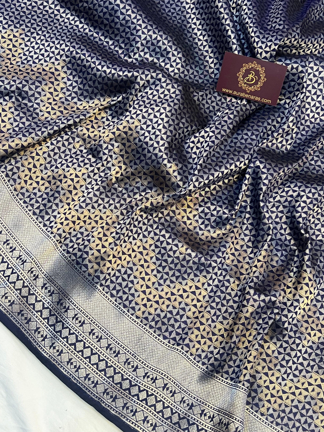 Silver zari geometric brocade work on pure Katan silk Banarasi saree with golden zig-zag skirt pattern