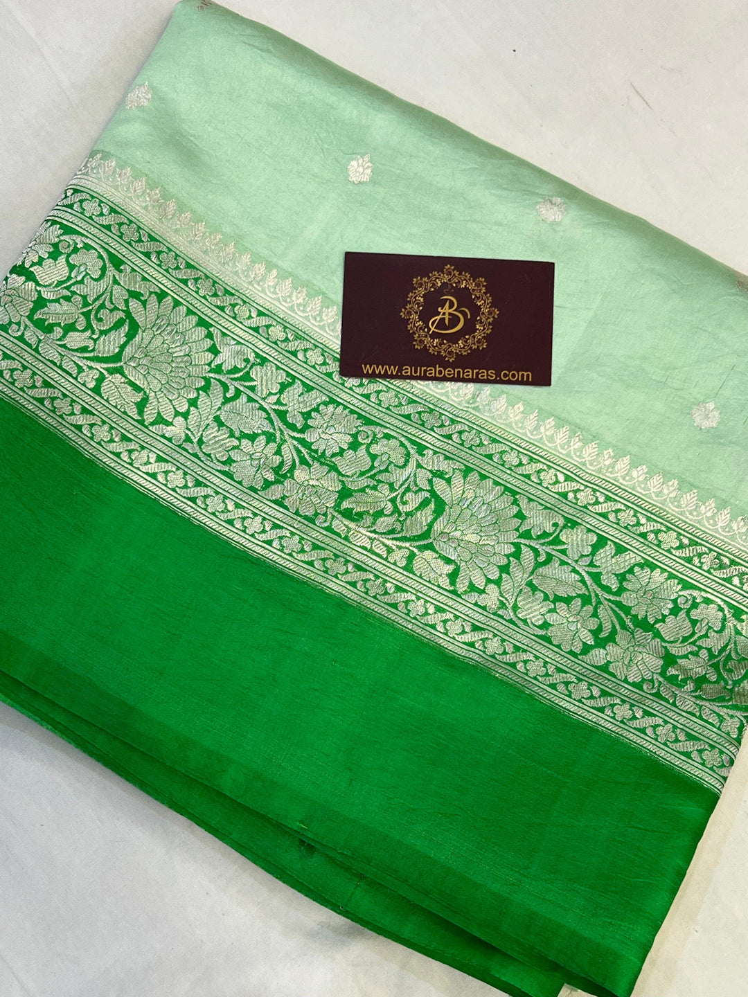 Intricate silver zari Kadhwa buta and buti on Banarasi pure silk saree