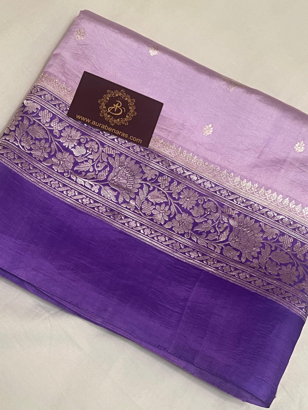Intricate silver zari Kadhwa buta and buti on Banarasi pure silk saree