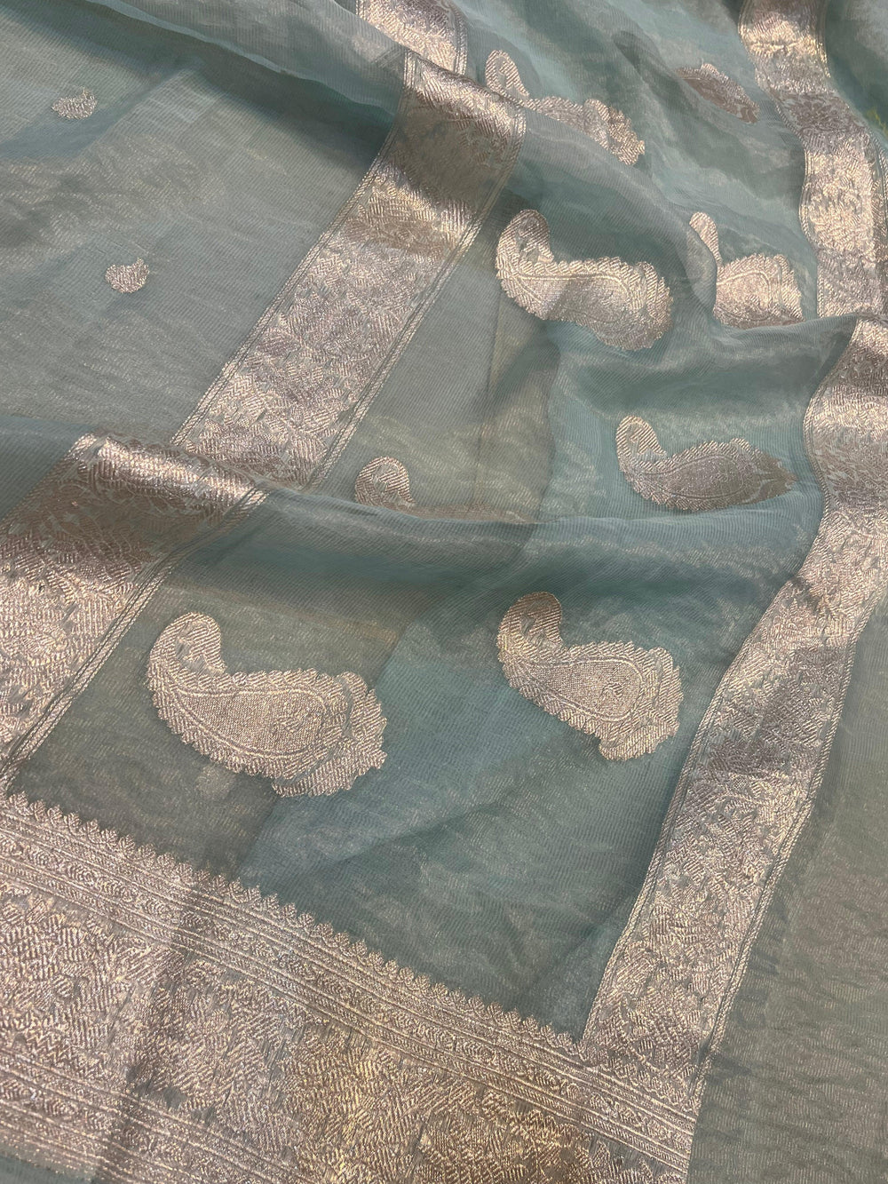 Silver zari Kadhwa border and handwoven butis on Banarasi tissue silk saree