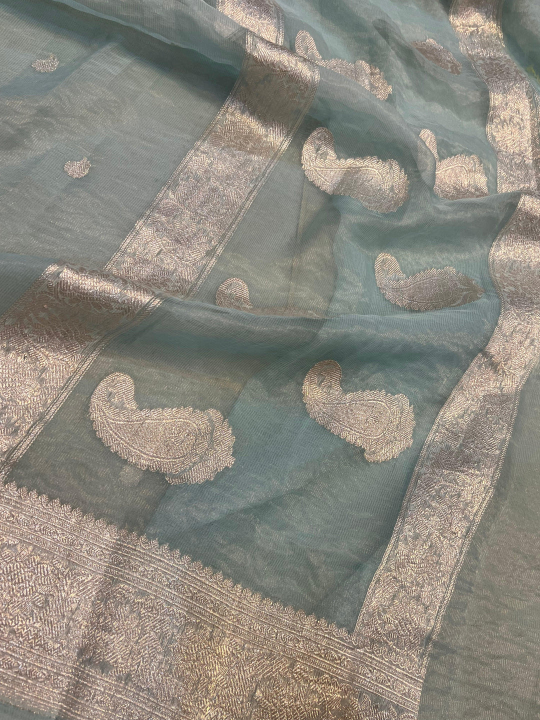 Silver zari Kadhwa border and handwoven butis on Banarasi tissue silk saree