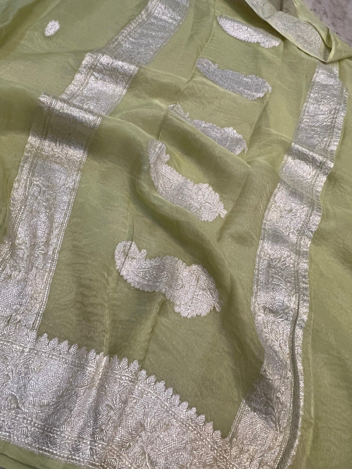 Silver zari Kadhwa border and handwoven butis on Banarasi tissue silk saree