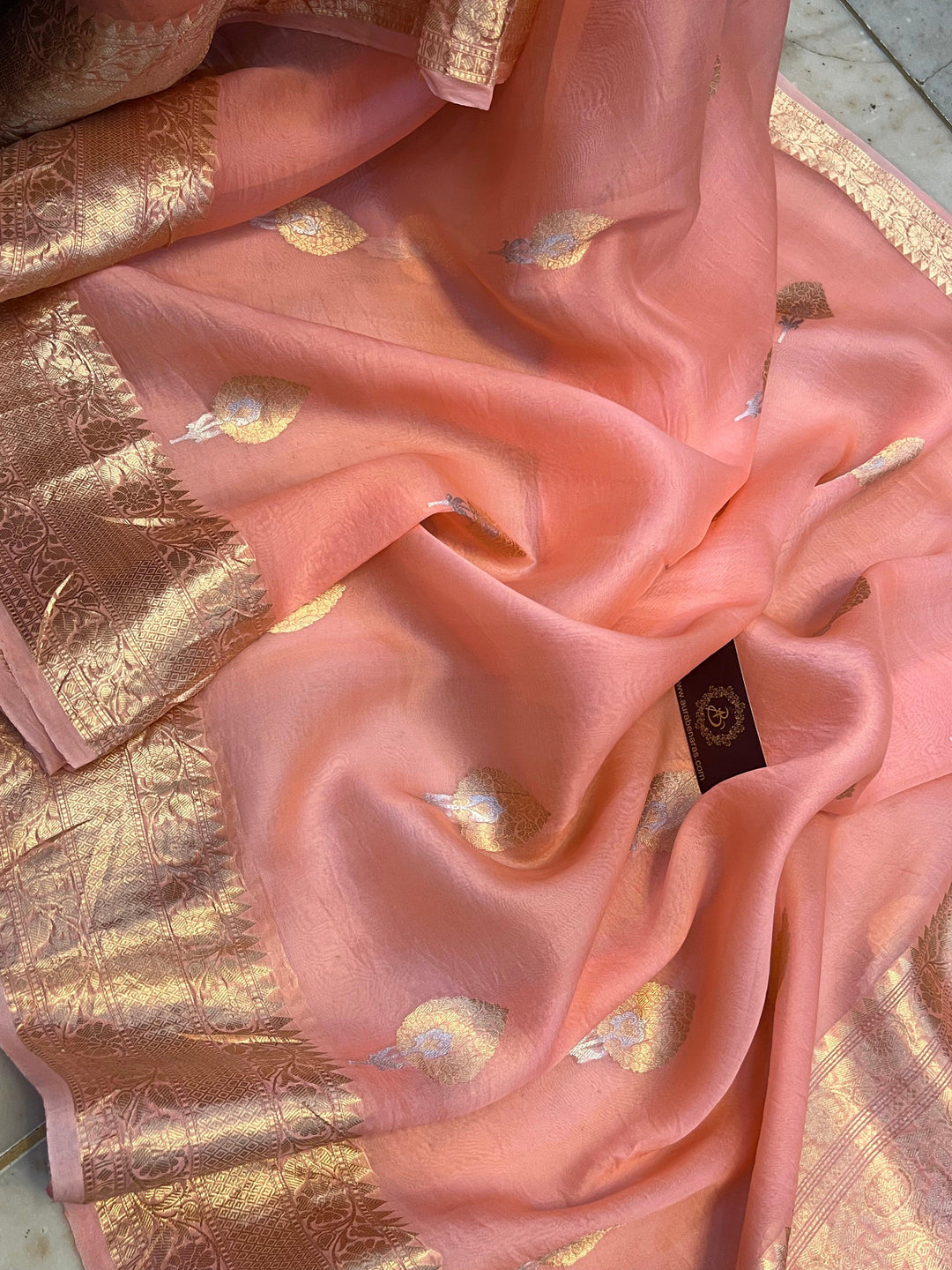 Close-up of the golden zari pallu with intricate Kadhwa Sona Rupa weaving on Kora silk fabric