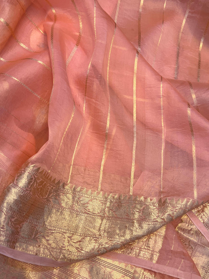 Unstitched striped blouse piece with zari border, paired with the Kora silk Banarasi saree
